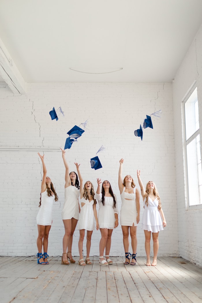 Graduates celebrating, throwing their caps in the air