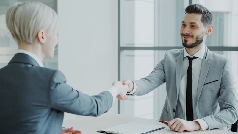 Two professionals shaking hands after a business meeting